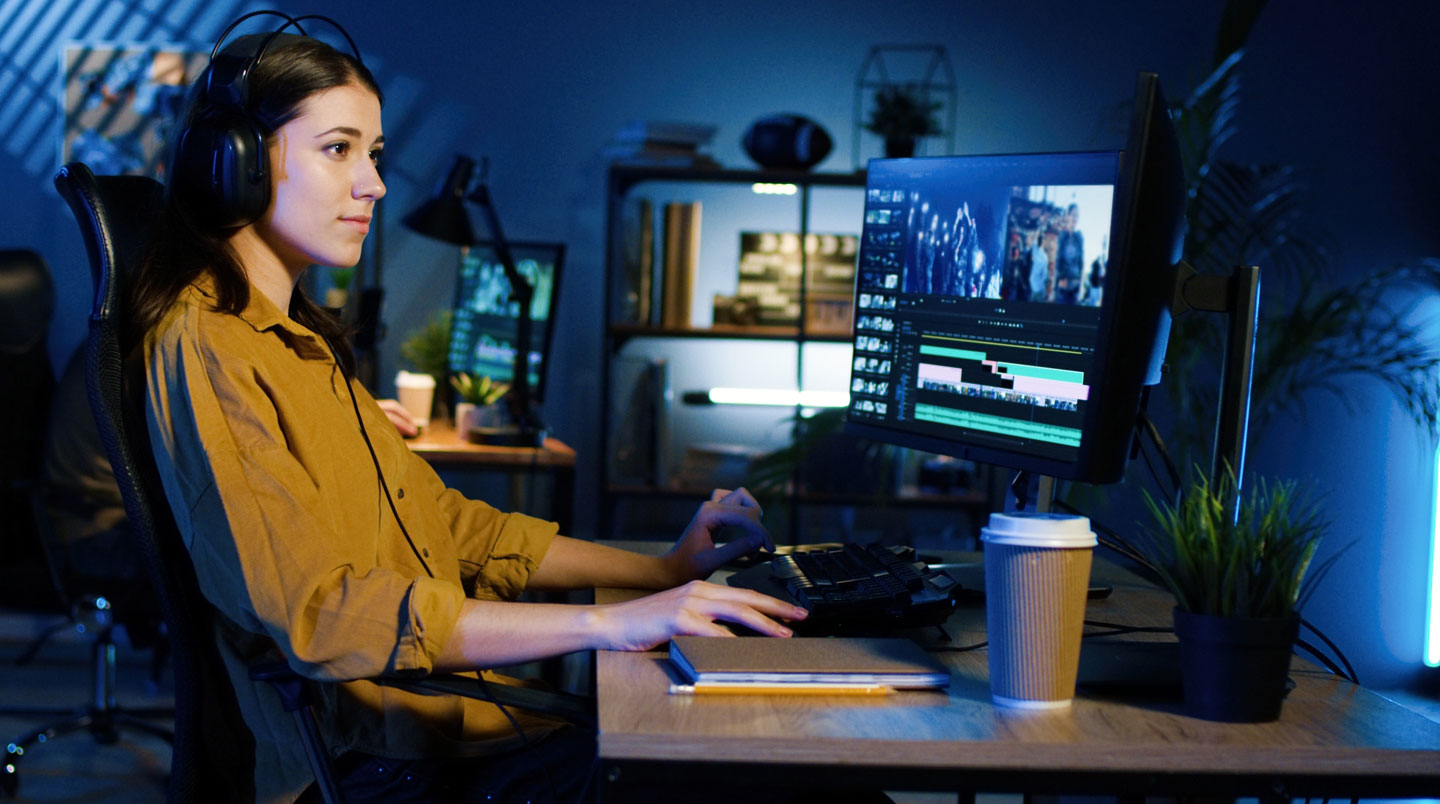 Hands on a laptop trackpad with a coffee cup nearby in a casual workspace setting